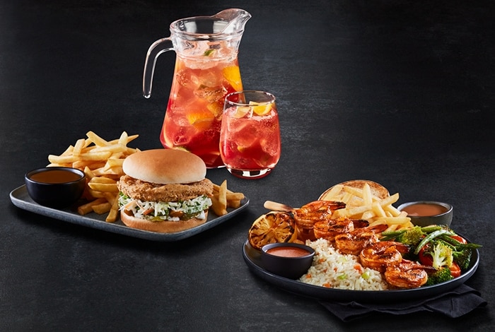 Pitcher with a cocktail, Crunchy veggie burger meal and Shrimp Brochette meal